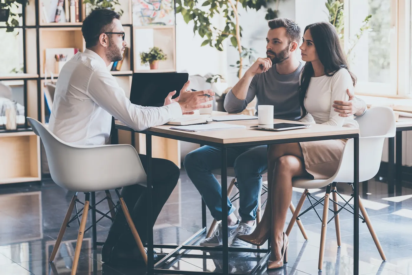 Advisors meeting with clients in a bright office