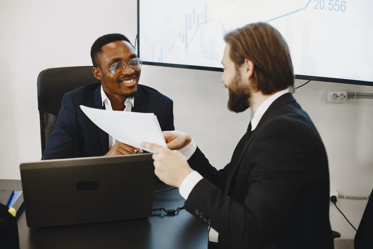 Two advisors discussing a document